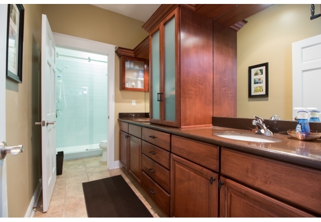 A beautifully updated master bathroom with custom cabinetry in a 1 bedroom in Regents Park.