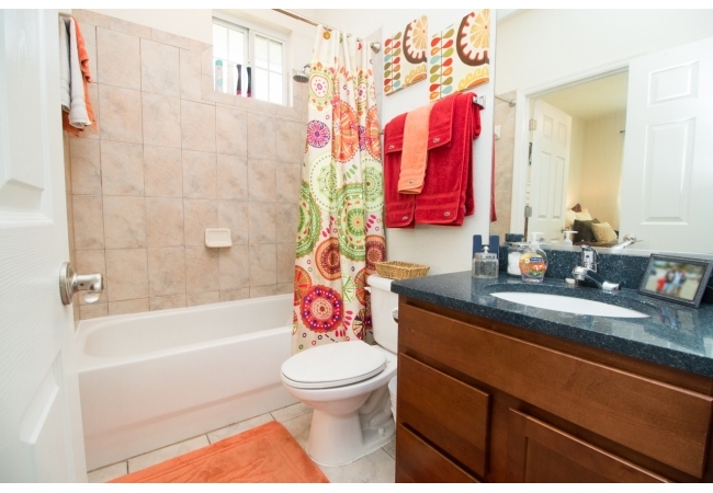 Shower/tubs are tiled and vanities have quartz countertops.